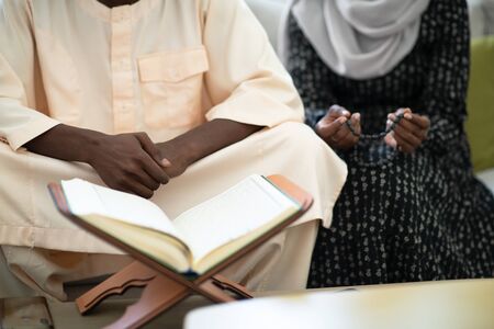 african muslim couple at home in ramadan reading quran holly islam bookの写真素材