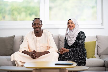 african muslim couple at home in ramadan reading quran holly islam bookの写真素材