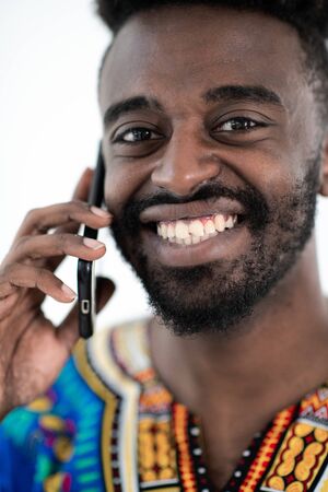 natuve sudan african male talking by smart phone isolated on white backgroundの写真素材