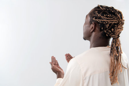 Handsome Young  African Muslim Man Making Traditional Fatiha Prayer To Allah God While Wearing A...
