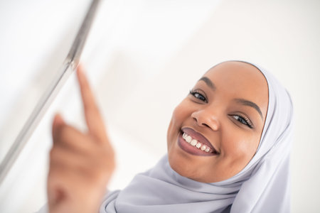 African woman using smart home screen control system