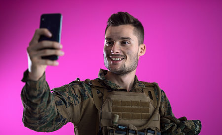 army soldier using smartphone to contact family or girlfriend communication and nostalgia concept...