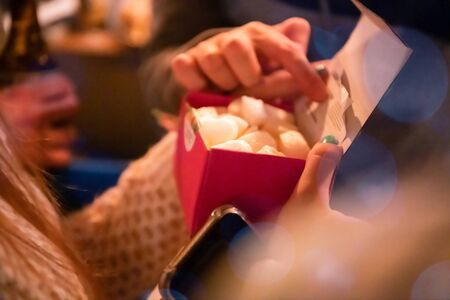 new year and christmas office party close up details food preparing and eating drinks and gifts authentic local startup business teamの写真素材