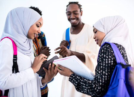 group of happy african students having conversation and team meeting working together on homework girls wearing traidiional sudan muslim hijab fashionの写真素材
