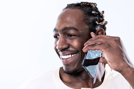 african man using smartphone and wearing traditioinal sudan clothes isolated on white backgroundの写真素材