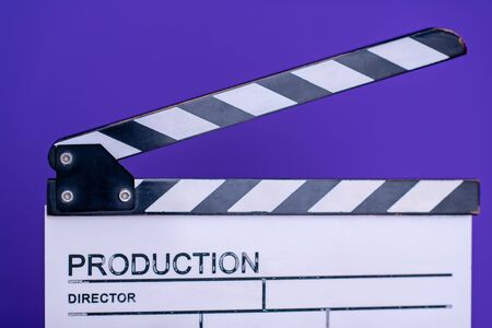 video production movie clapper cinema action and cut concept isolated on purple violet backgroundの写真素材