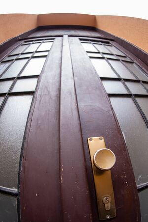 Close up outdoor view of an old wooden double door with glass windows  Abstract architectural picture  classical house entrance door, street vintage doorsの写真素材