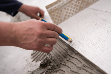 skilled worker installing the ceramic wood effect tiles on the floor Worker making laminate flooring...
