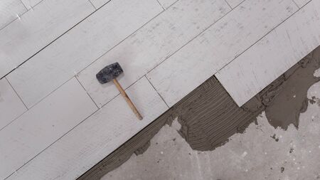 Ceramic wood effect tiles and tools for tiler on the floor  unfinished laying floor tiles  Floor tiles installationの写真素材