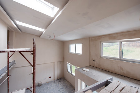 interior of construction site with scaffolding in a large modern unfinished duplex apartment