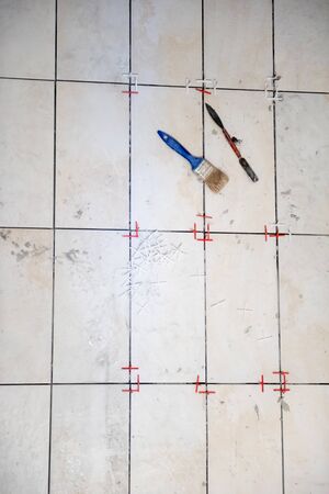 Ceramic tiles and tools for tiler  ceramic tiles installation  Home improvement, renovation   ceramic tile adhesive, mortar, levelの写真素材