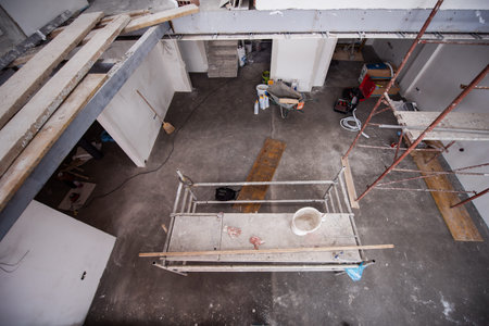 interior of construction site with scaffolding in a large modern unfinished duplex apartment