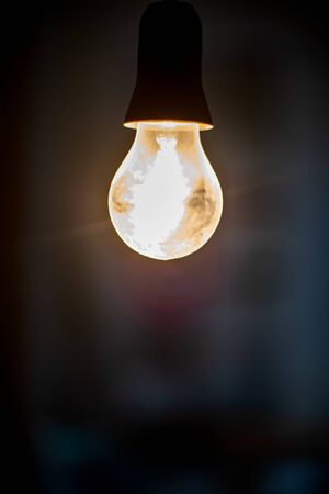 Electric lighting bulb on the dark backgroundの写真素材