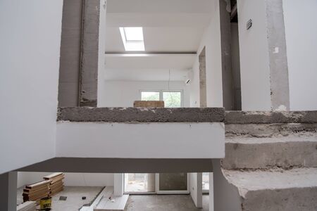 interior of construction site with drywall completely installed at new two level apartment  work in progress to the new houseの写真素材