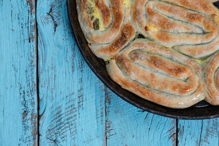burek pie in a rustic wooden blue setting background and authentic dish,  top view flat layoutの写真素材