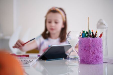 Mother and little daughter  playing together  drawing creative artwork during coronavirus quarantineの写真素材