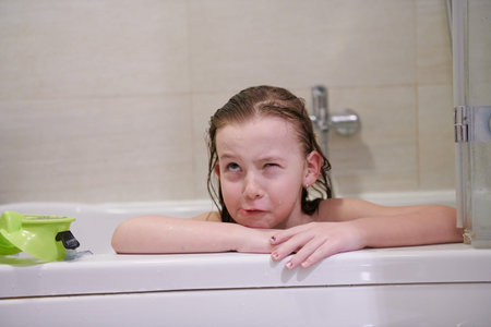little girl with snorkel goggles in the tub while taking a bath in the bathtub, kids hygiene concept...