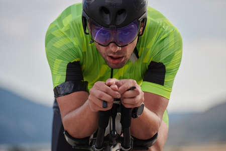 closeu of triathlon athlete riding professional racing bike at workoutの写真素材