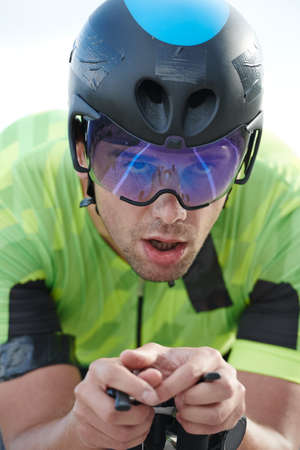 closeu of triathlon athlete riding professional racing bike at workoutの写真素材