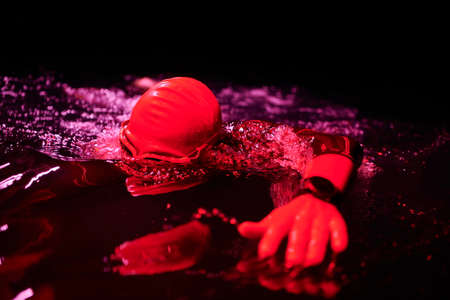 real triathlon athlete swimming in dark nightの写真素材