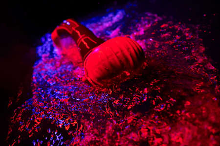 real triathlon athlete swimming in dark nightの写真素材