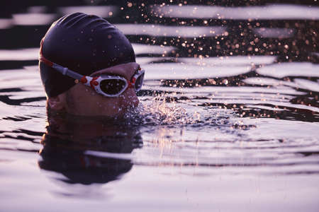 triathlete swimmer having a break during hard trainingの写真素材