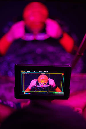 videographer taking action shot of triathlon swimming athlete at nightの写真素材