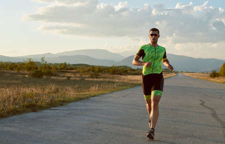 triathlon athlete running on morning trainigの写真素材