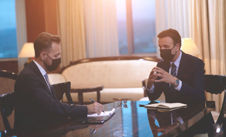 business people wearing crona virus protection face mask on meetingの写真素材