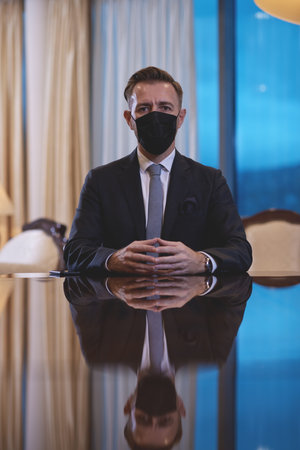 business man wearing protective face mask at luxury officeの写真素材