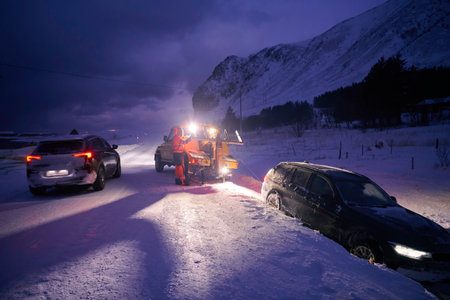Car being towed after accident in snow stormの写真素材