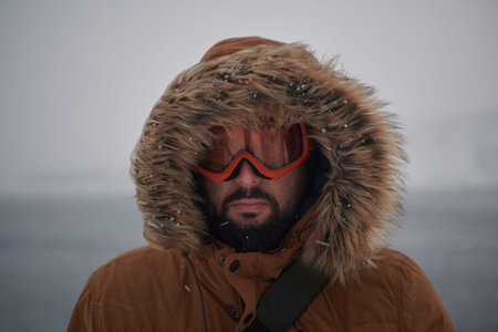 man at winter in stormy weather wearing warm fur jacket