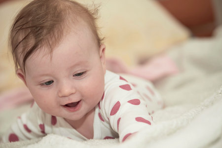 cute little baby playing with hands and smilingの写真素材