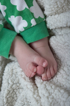 closeup of bared feet of six months old baby