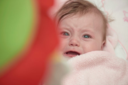 cute little baby in bed crying