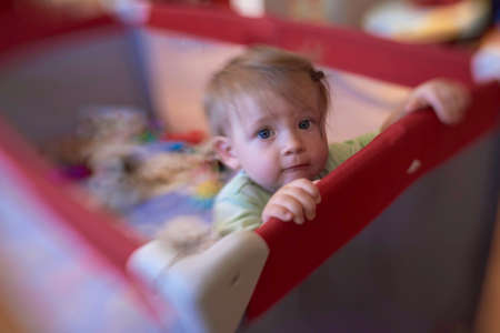 cute little baby playing in mobile bedの写真素材