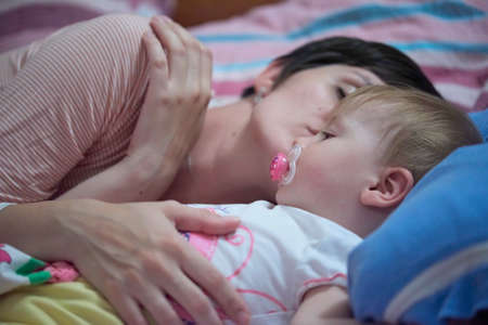 mother is playing with baby at homeの写真素材