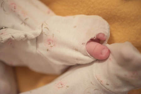 One month newborn baby sleeping in bedの写真素材