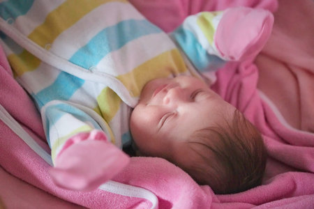 newborn baby sleeping at home in bed