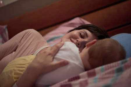 mother is playing with baby at homeの写真素材
