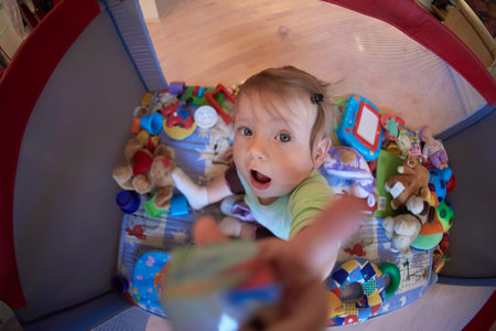 cute little baby playing in mobile bedの写真素材