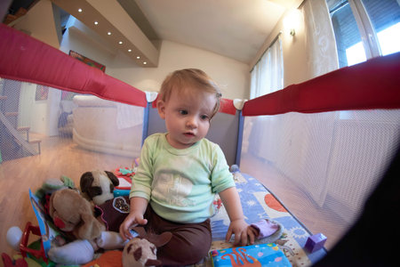cute little baby playing in mobile bed