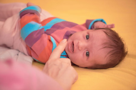One month newborn baby sleeping in bed