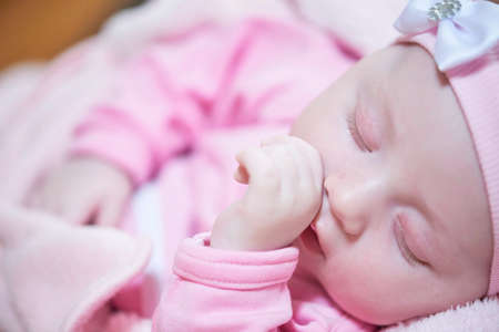 newborn baby sleeping at home in bedの写真素材