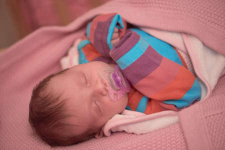 One month newborn baby sleeping in bedの写真素材