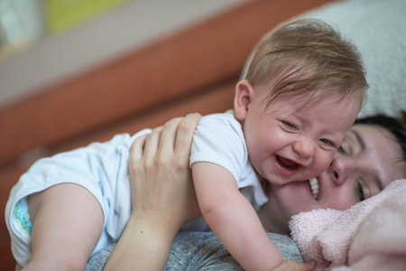mother is playing with baby at home
