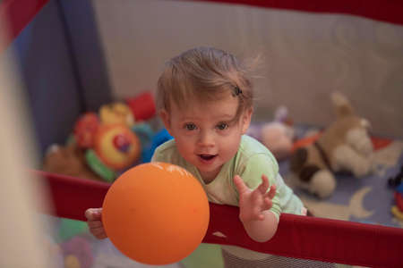 cute little baby playing in mobile bedの写真素材