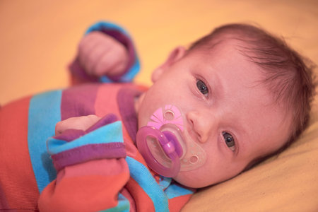 One month newborn baby sleeping in bed
