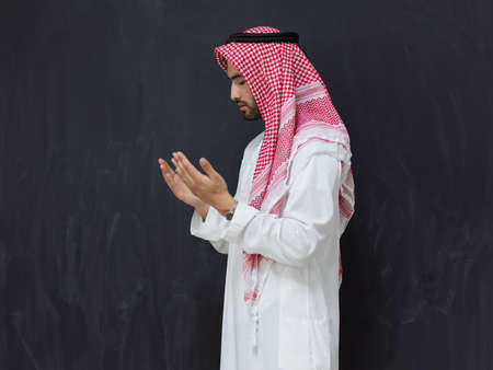 Arab man in traditional clothes praying to God or making duaの写真素材
