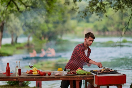 man cooking tasty food for french dinner partyの写真素材